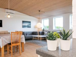 a living room with two potted plants on a counter at 6 person holiday home in Faaborg in Faaborg