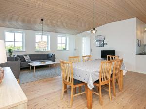 a dining room and living room with a table and chairs at 6 person holiday home in Faaborg in Faaborg