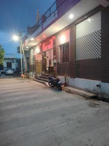 a motorcycle parked outside of a gas station at night at Bhardwaj Home Stay in Mathura