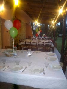 a white table with plates and balloons on it at Agriturismo Il Selvello in Montemassi