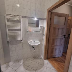 a bathroom with a sink and a mirror at Dom Brama Mazur in Ostróda +68 photos
