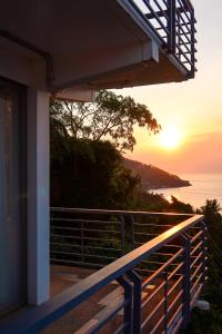 a view of the sunset from the balcony of a house at AV Suites in Puerto Galera
