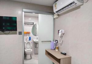 a hospital room with a toilet and a tv at New Star Guest House in Hong Kong +175 photos