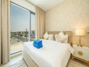 a bedroom with a white bed with a large window at NewArabian Dubai HillsMaple Villa in Dubai +241 photos