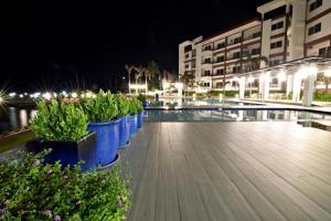 a row of blue planters in a pool at night at Holiday Oceanview Residences and Resort in Davao City