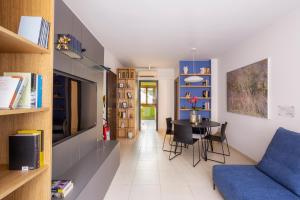 a living room with a blue couch and a table at DOMUS Matteotti in Ancona
