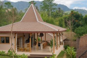 a small house with a pitched roof at Tebola Joglo Villas in Sidemen