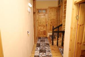 a hallway with a door and a rug at Farid HOSTEL in Ganja