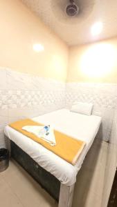a room with a bed with a tray on it at Hotel firdous in Mumbai