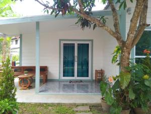 a front porch of a house with a glass door at WinLa house in Ban Nua