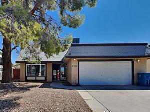 a house with a garage and a tree at Style and Comfort in Las Vegas