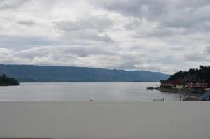 a view of a large body of water with mountains at OPRISS HOTEL in Parapat +19 photos