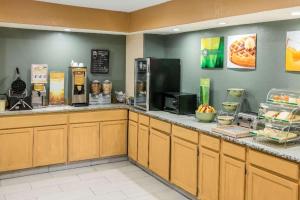 a fast food restaurant with a counter with food at Quality Inn in Albuquerque