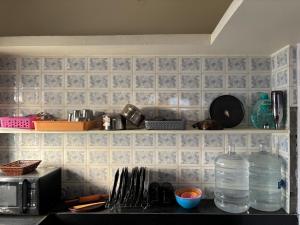 a kitchen with a counter with a sink and a microwave at Modern 4 BHK in Hyderabad +13 photos