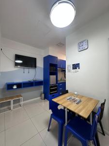 ein Esszimmer mit einem Holztisch und blauen Schränken in der Unterkunft reStary room 2 in Kota Kinabalu