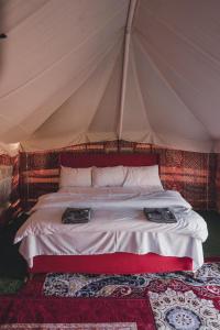 a bedroom with a bed in a tent at layali camp in Bidiyah