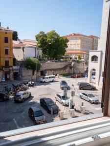 a view from a window of a parking lot with cars at Apartment Ana in Pula
