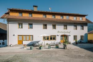 a large white building with a patio in front of it at Merlschober, Ferienwohnung 8, Ossiacher See in Ossiach