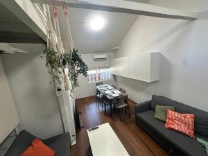 a living room with a couch and a table at 3BR Entire Home, 1 Min to Midosuji Line, Sleeps 10 in Osaka
