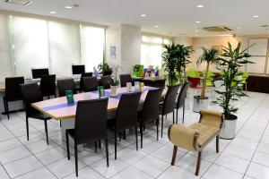 a conference room with a long table and chairs at Kyoto Plaza Hotel in Kyoto