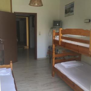 a room with two bunk beds and a hallway at Thomas Apartments in Kanali