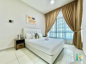 a bedroom with a large white bed and a window at Parc Regency by RR JBcity in Johor Bahru