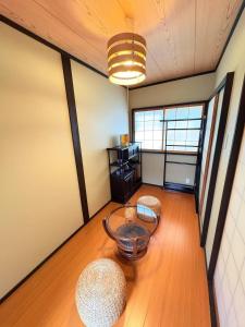 a living room with a table and two chairs at 夏様楽善 Historic Kyoto Machiya,Experience Japanese Lifestyle Comfortably in Kyoto