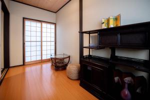 a living room with a wooden floor and a window at 夏様楽善 Historic Kyoto Machiya,Experience Japanese Lifestyle Comfortably in Kyoto