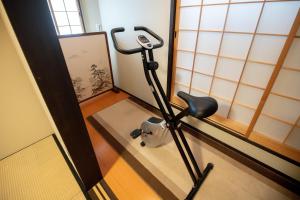 a room with a treadmill in front of a window at 夏様楽善 Historic Kyoto Machiya,Experience Japanese Lifestyle Comfortably in Kyoto