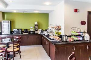 a kitchen with a counter with a table and chairs at Sleep Inn Airport - Billy Graham Parkway in Charlotte +90 photos