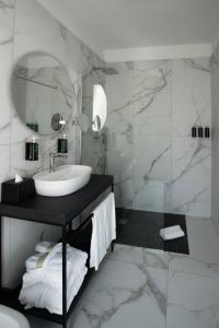 a bathroom with a sink and a mirror at Melia Venezia Lido in Venice-Lido