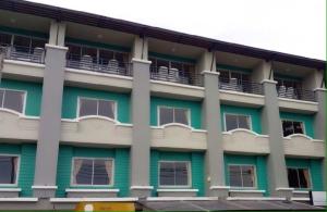 a green and white building with windows and balconies at Orchid Residence Samui in Chaweng