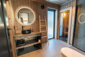 a bathroom with a sink and a mirror at Spacious lodge with sauna, ski centre in Noresund +62 photos