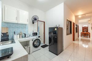 a kitchen with a refrigerator and a counter top at The Coastal Haven Holiday Home, Karon Beach in Karon Beach