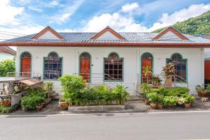 a white building with plants in front of it at The Coastal Haven Holiday Home, Karon Beach in Karon Beach