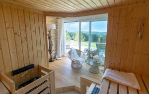 a room with a large window in a wooden cabin at Ferienhäuser Hoher Knochen in Winterberg