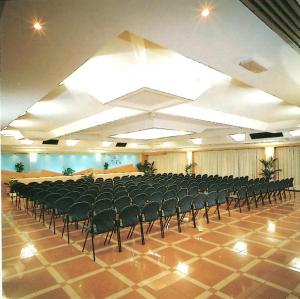 a large room with a lot of chairs in it at Hotel Piol in Limana