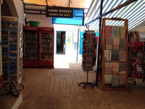 an aisle of a store with items on display at Faros Rooms in Loutro