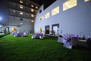 a room with purple tables and chairs on the grass at Hotel Gandharva- A Green Hotel in Jaipur