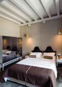 a hotel room with two beds and two lamps at XII Century Heritage Hotel in Trogir