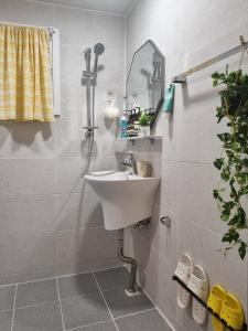 a bathroom with a sink and a mirror at Ye Stay in Daegu