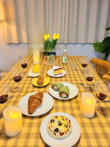 a table with plates of food and glasses of wine at Ye-stay in Daegu
