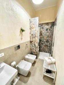 a bathroom with a sink and a toilet and a shower at a casa rà Palumma Rooms in Avola