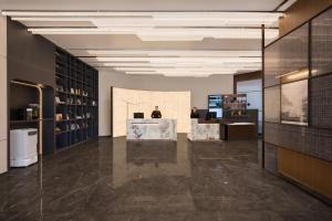 a large room with a lobby with a desk and shelves at Atour S Hotel Beijing Zhongguancun Institute of Technology in Beijing