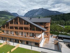 an aerial view of a house with mountains in the background at Alpen Experience Apart Hotel in Gröbming
