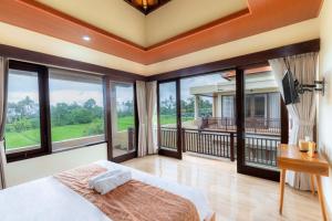 a bedroom with a bed and large glass windows at Jnana Bali Villa in Saba +18 photos