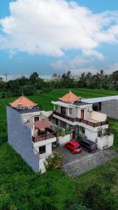 a house with a red car parked in front of it at Jnana Bali Villa in Saba