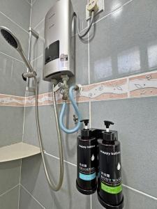 a shower with two blow dryers in a bathroom at Arena Lobak Villa Retreat, Spacious Stay with Billiards, Karaoke, BBQ in Seremban