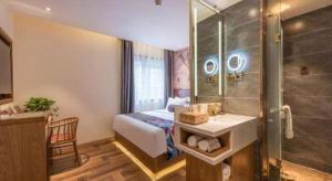 a bathroom with a bed and a shower and a sink at James Joyce Coffetel Beijing Station in Beijing +206 photos
