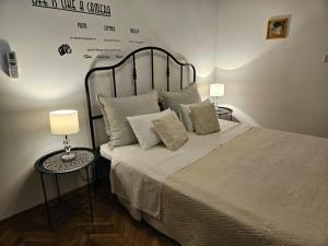 a bedroom with a bed with pillows and two lamps at Gorana studio apartment in Jelsa